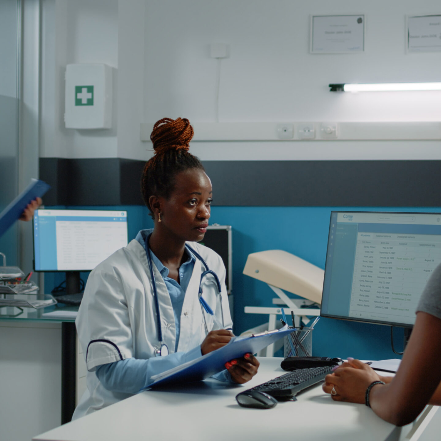 African doctor and patient doing consultation for treatment against disease. Woman explaining pain and sickness to medic at annual checkup visit. Black people at examination